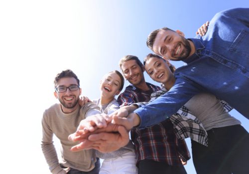 active young people ,with hands clasped together.photo with copy space